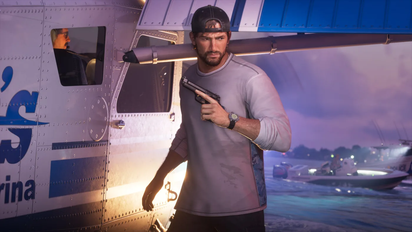 Jason holding a phone beside a boat